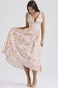 Detail of pink floral maxi dress showing the flowing fabric and elegant drape on a model