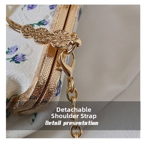 Detail of detachable gold chain strap and floral embroidery on lace shell bag