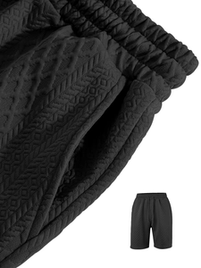 Detailed macro view of black waffle knit fabric and elastic waistband on men shorts