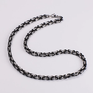 Detail of luxury black and silver byzantine chain necklace with high-polish finish