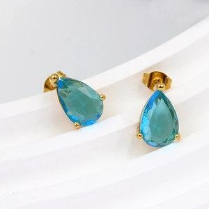Detail of sky blue teardrop zircon earrings with elegant 18K gold plated prong setting