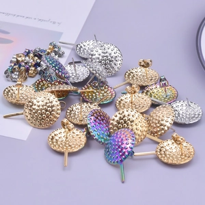 Macro detail of round 304 stainless steel earring studs in gold, silver, and rainbow colors