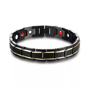 Men's magnetic therapy bracelet in black and gold stainless steel on white background