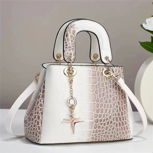 White faux crocodile leather handbag with elegant gold hardware and star charm pendant