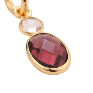 Gold plated hoop earring with faceted red gemstone and small clear crystal detail