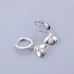 Detail of bee drop earrings in S925 sterling silver with sparkling white zircon insets
