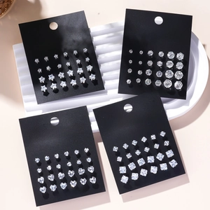 Set of 12 pairs of geometric zircon stud earrings in heart and star shapes on black cards