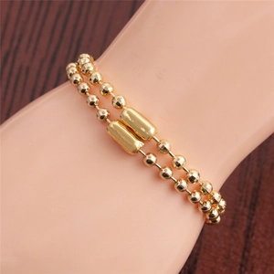 Elegant gold double-strand beaded bracelet on wrist with professional metallic luster