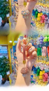 Close-up detail of mushroom-shaped keychain with full sparkling rhinestones on alloy base