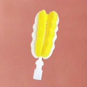 Detail of detachable wave-shaped sponge head on a long handle baby bottle cleaning brush