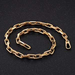 Detailed macro view of 10mm gold titanium steel chain link with lobster clasp closure
