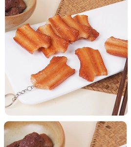 Detailed view of realistic braised pork belly keychain with glossy sauce texture