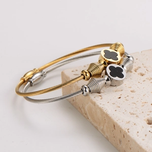 Clover cable wire bangle set in gold and silver finish on stone display base