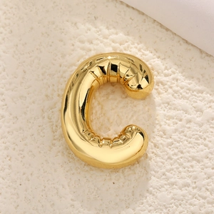 Close-up of gold-plated puffy letter C pendant with a shiny metallic 3D balloon effect