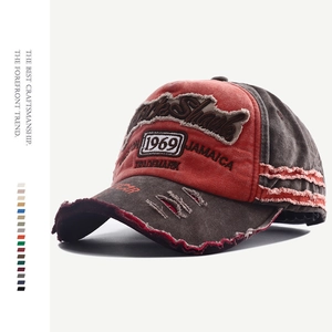 Detail of red and charcoal vintage washed baseball cap with 1969 embroidery and distressing