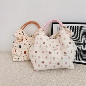 Close-up of quilted bubble texture fabric handbag with cute cartoon animal prints