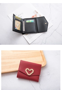 Detail view of tri-fold wallets featuring heart gold buckle and multi-card slots interior