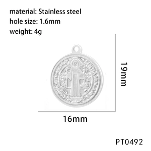 Macro shot of silver stainless steel Saint Benedict religious medal with 16mm diameter