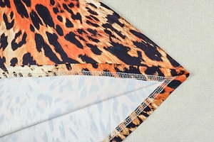 Detail of the high-quality overlock stitching on the hem of a leopard print elastic dress