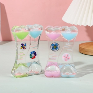 Dual heart-shaped liquid motion bubbler with rotating windmill and colorful floating icons