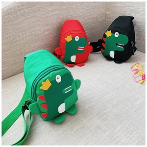 Detailed view of kids dinosaur crossbody bags in green red and black nylon