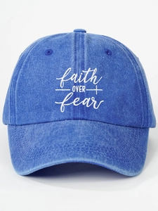 Detailed view of white Faith Over Fear embroidery on washed blue denim baseball cap