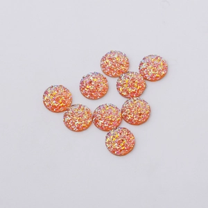 Detail of 12mm orange resin drusy cabochons with sparkling glitter for jewelry making