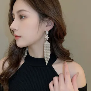 Elegant long fringe tassel flower earrings with rhinestones on a female model