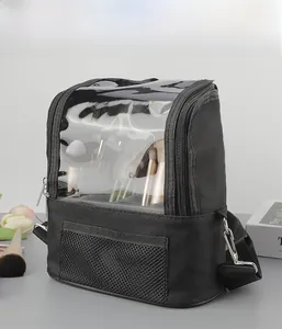 Close-up of black makeup bag with transparent PVC window and adjustable shoulder strap