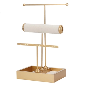 Golden 3-tier jewelry organizer stand with white velvet rolls and multi-grid base