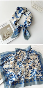 Detail of silk scarf showing smooth satin texture and navy floral botanical pattern