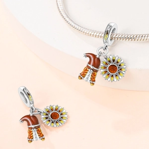 Detail of silver gnome and sunflower charm on a bracelet with enamel finish