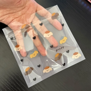 Close-up of clear cartoon puppy ziplock bag showing transparency and cute dog graphics