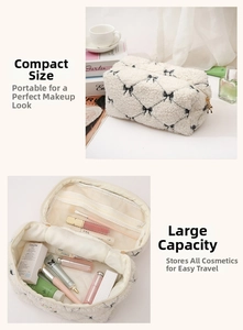 Detail view of lamb wool makeup bag with black bow pattern and mesh interior pockets