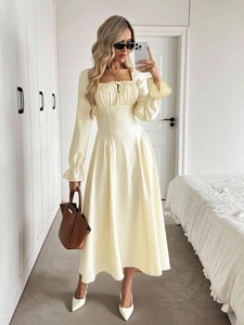 Detail of square neckline with drawstring and ruffled cuffs on a cream A-line dress
