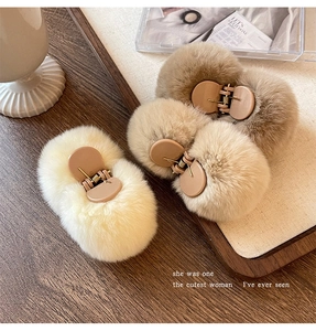 Detailed view of three khaki plush hair claws on a tray for elegant autumn hair styling