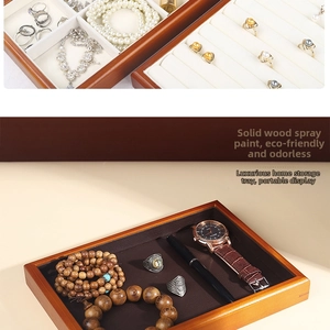 Macro view of solid wood jewelry organizer trays with ring slots and leather lining