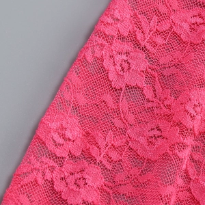 Close-up of rose pink lace fabric showing detailed floral embroidery and texture
