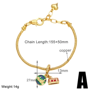 Detailed view of golden copper bracelet with globe charm and red house pendant