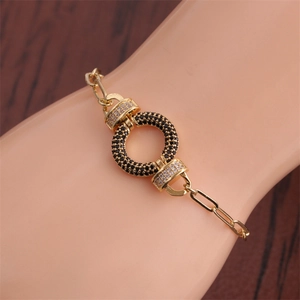 Detail of hip hop bracelet featuring golden chain and black zircon inlaid center ring