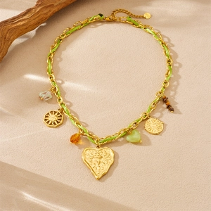 Gold chain and green woven cord necklace with heart pendant and sun charms