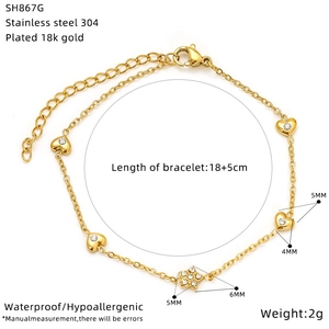 Detail of 18K gold plated stainless steel bracelet with zircon heart and star charms