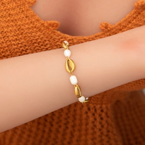 Women's 18K gold plated bracelet featuring golden shell charms and elegant white pearls