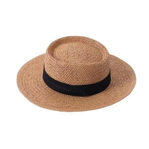 Wide brim straw sun hat with black ribbon decoration for summer beach and vacation