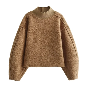 Detailed macro view of brown textured fleece fabric and ribbed neckline on sweater
