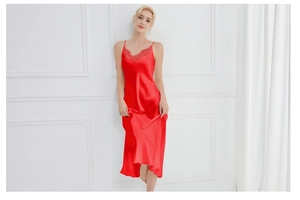Detail of red silk slip dress featuring V-neckline with delicate lace embroidery