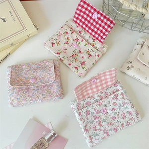 Detailed view of floral canvas coin purses with snap buttons and plaid lining