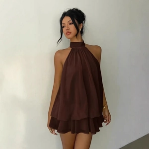 Detail of layered ruffle hem on brown halter neck chiffon vacation mini dress