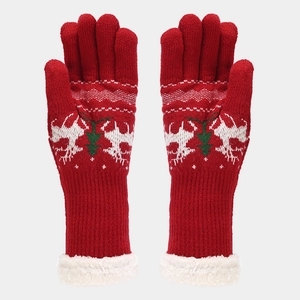 Close-up of red Christmas knit gloves with reindeer pattern and white faux fur cuffs