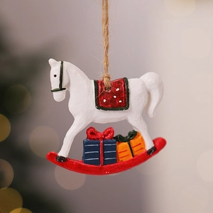 Detail of vintage resin rocking horse Christmas ornament with red saddle and jute rope